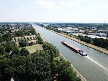 High angle view of river amidst trees against sky