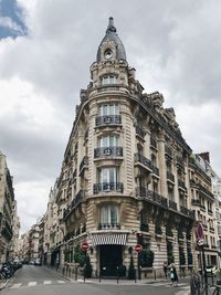 Low angle view of building against cloudy sky