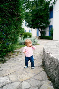 Full length of cute baby walking on footpath