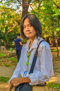 Portrait of young woman sitting on field