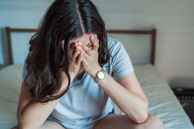 Midsection of woman sitting at home