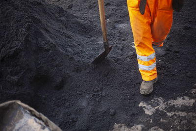 Low section of man walking on road