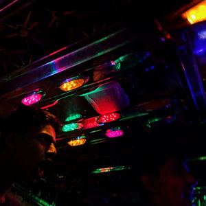 Portrait of woman with illuminated lights in the dark