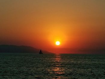 Scenic view of sea against orange sky