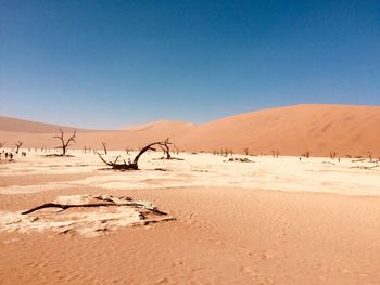 Scenic view of desert against clear blue sky