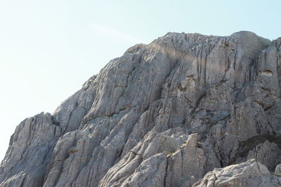 Low angle view of rock formation against clear sky