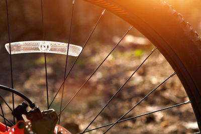 Close-up of bicycle wheel on field