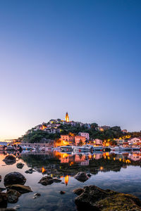 Beautiful view over a fishing port of a mediterranean mountain village on the coast in twilight. krk