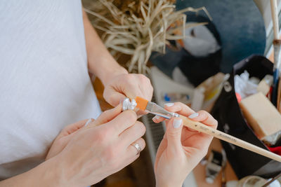 Cropped hand of woman holding syringe