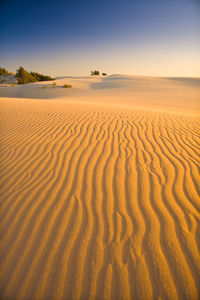 Scenic view of desert against sky during sunset