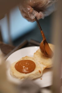 Midsection of person holding bread on table