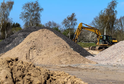 Construction site by road against sky