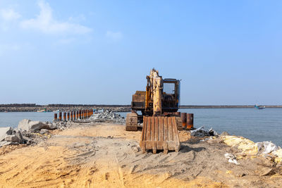 Built structure on beach against sky