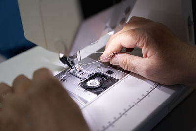 The workplace of a seamstress. the dressmaker works on a sewing machine. hobby or a small business