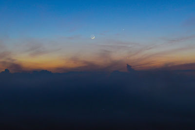 Low angle view of silhouette moon against sky at sunset