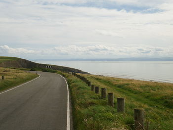 Empty road along countryside landscape