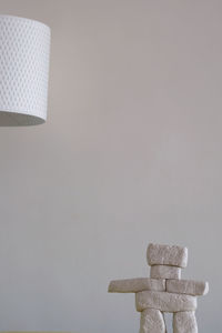 Close-up of electric lamp against white wall