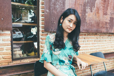 Portrait of beautiful young woman standing outdoors