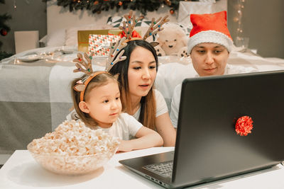 Cozy family christmas, happy fun and xmas holiday together at movie night or via video link