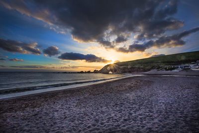 Scenic view of beach against sky during sunset