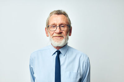 Portrait of young man standing against white background