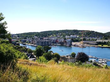 High angle view of river and cityscape against clear sky