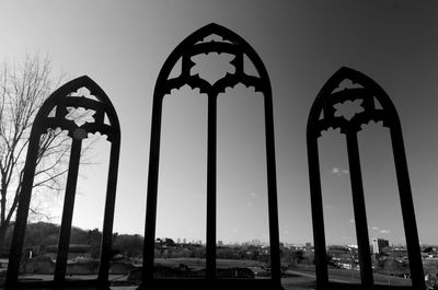 Low angle view of silhouette built structure against sky