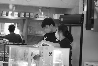 Man and women talking  at a shoop counter