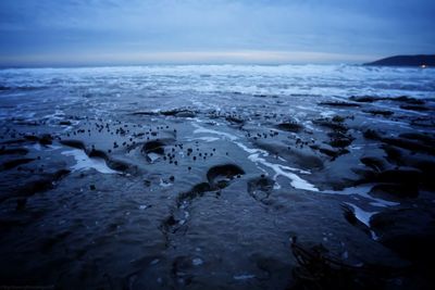 Scenic view of sea against sky during winter