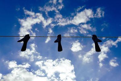 Low angle view of clothes hanging against sky