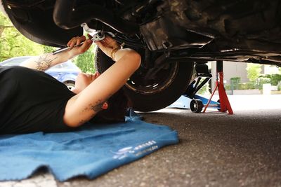 Woman repairing car wheel