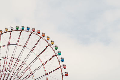 Low angle view of ferris wheel against sky