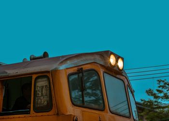 Low angle view of train against clear blue sky