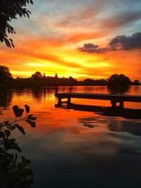 Scenic view of lake against orange sky