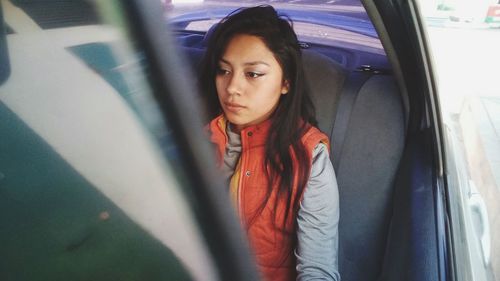 Portrait of young woman in car