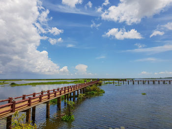 Pier over lake against sky