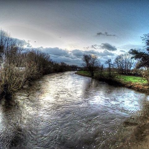 water, sky, tranquil scene, tranquility, tree, scenics, lake, river, beauty in nature, waterfront, nature, cloud - sky, rippled, reflection, stream, cloud, day, idyllic, non-urban scene, outdoors