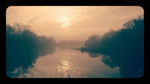 Scenic view of lake at sunset