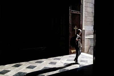 Man standing in corridor of building