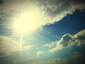 Low angle view of sun shining in sky