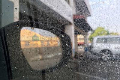 Close-up of wet car window in rainy season