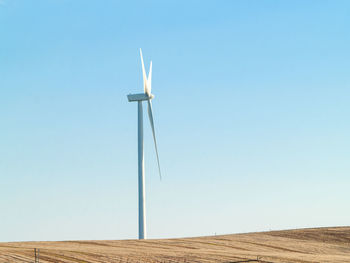 Low angle view of windmill against clear sky