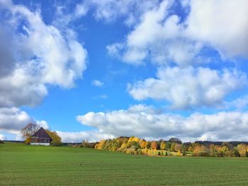 Scenic view of field against cloudy sky