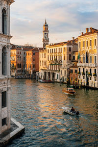 Buildings by grand canal in city