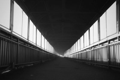 Empty road along bridge