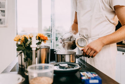 Midsection of man preparing food on table