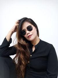 Portrait of beautiful young woman wearing sunglasses