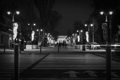 Illuminated street lights in city at night