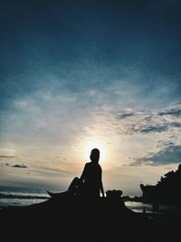 Silhouette people on beach at sunset