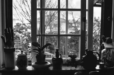Potted plants and containers on window sill